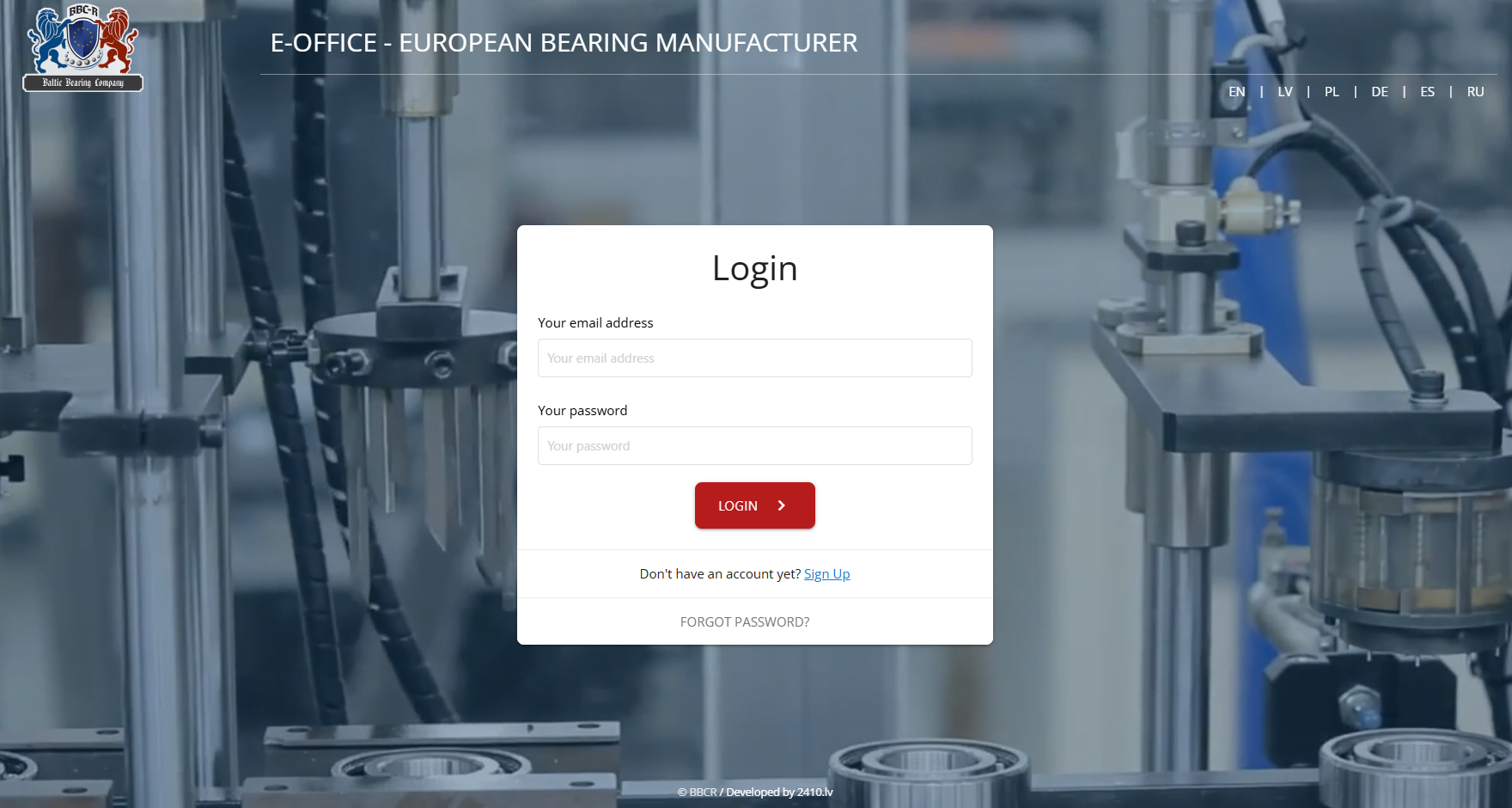 Schermata di accesso del portale E-Office con selettore multilingue e video di sfondo dalla linea di produzione.